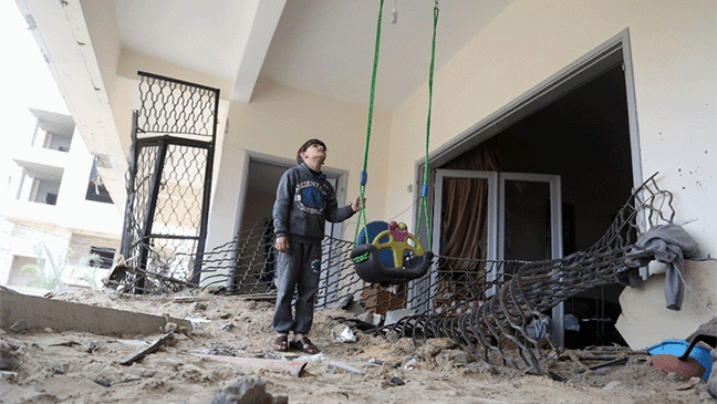 child inside school building that has been destroyed from conflict in gaza