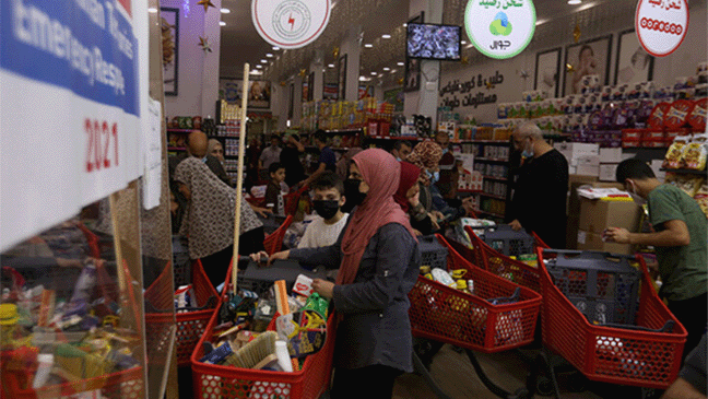 Families purchasing food at a supermarket in Gaza using food vouchers provided by Islamic Relief