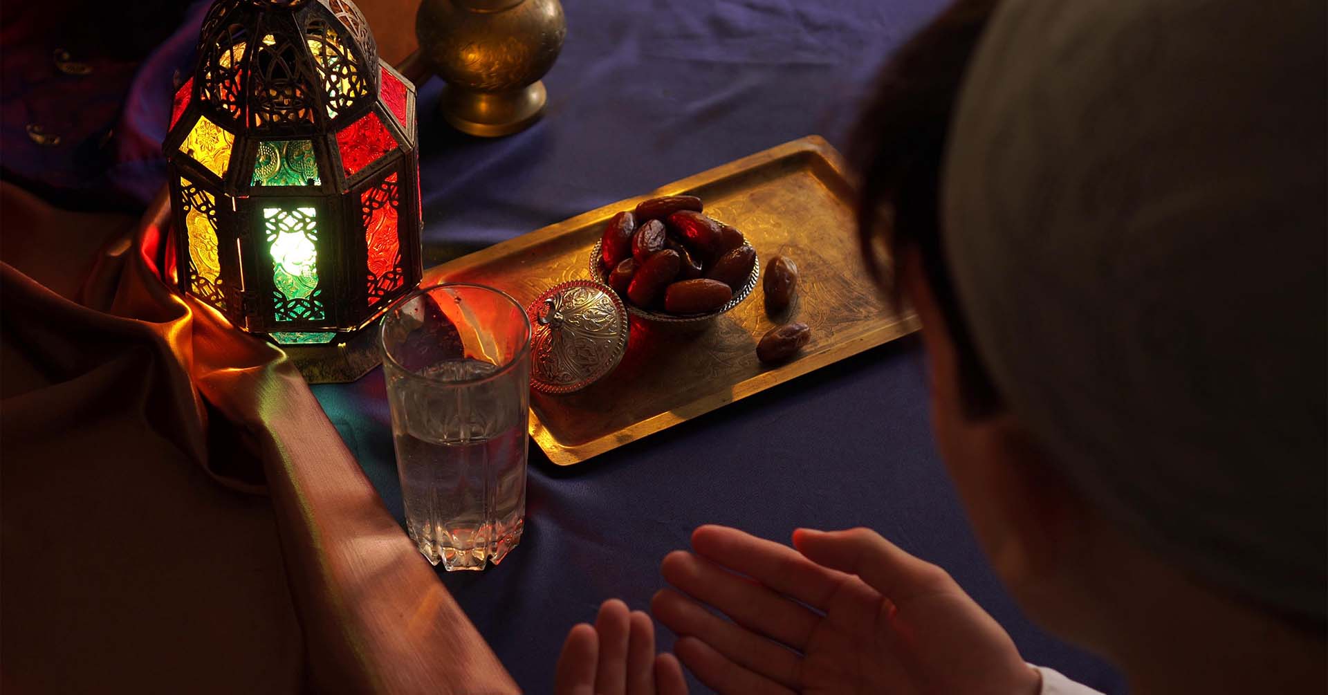 person making dua prayer with bowl of dates and glass of water fasting 15th shaban shab e baraat