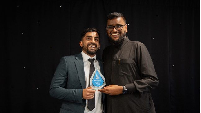 a trophy being handed to one of the winners of islamic relief's lifesavers award