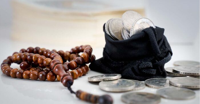 brown prayer beads (tasbih) and black pouch of silver coins charity in islam