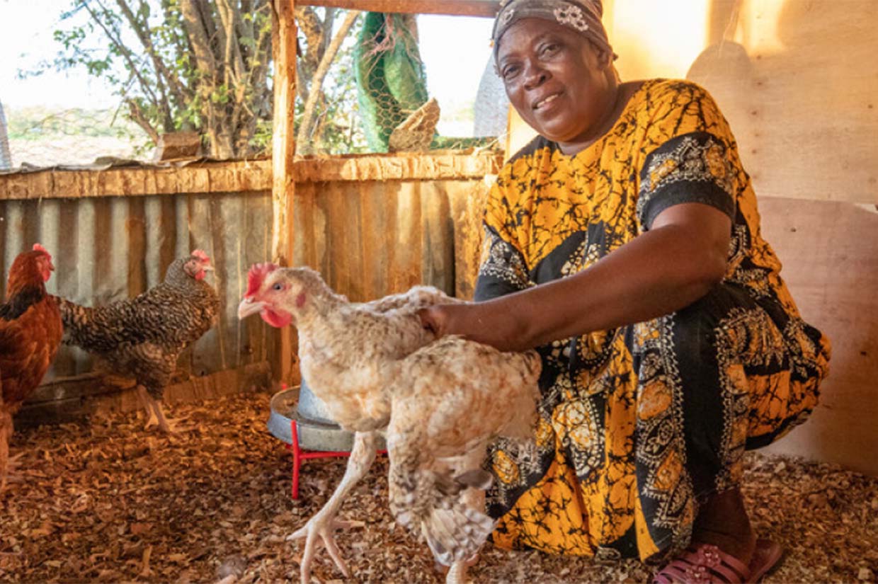 a woman holding a chicken