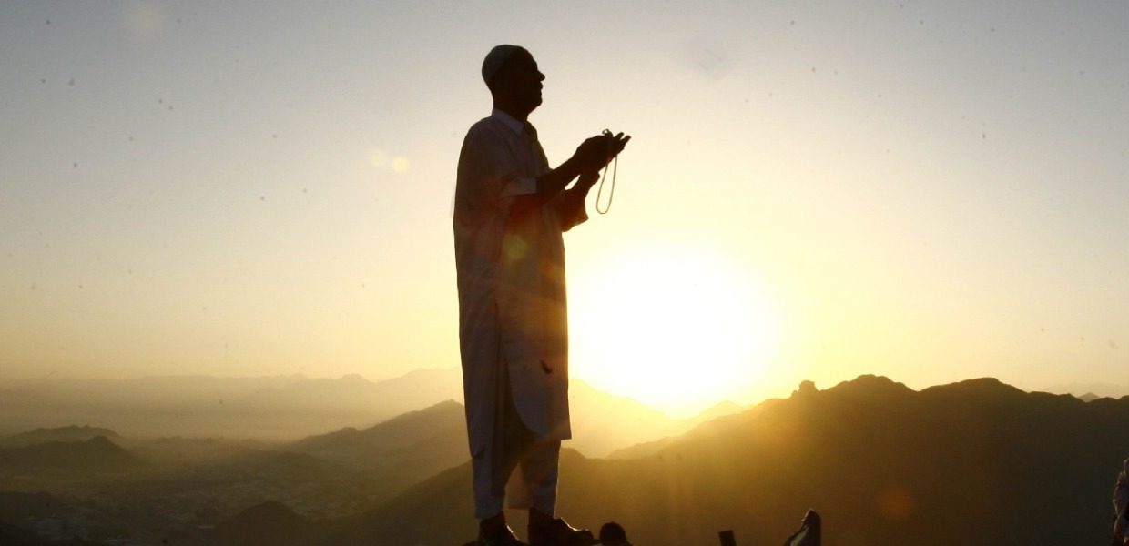 man making a dua on mount arafat