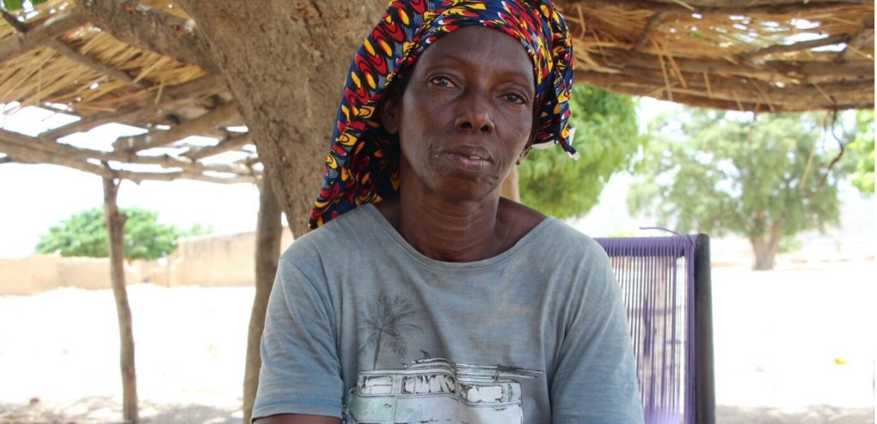 a malian woman called Fatoumata wearing a grey t-shirt and a colourful head wrap