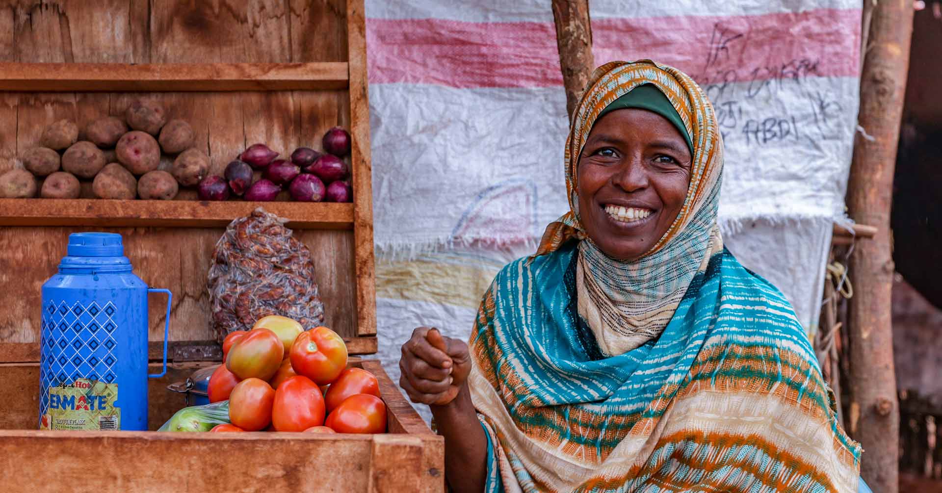 woman from kenya smiling after receiving food pack islamic relief