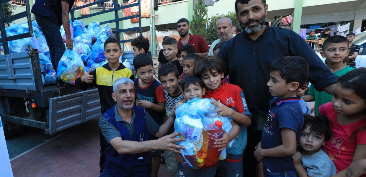 islamic relief staff in gaza with a group of children