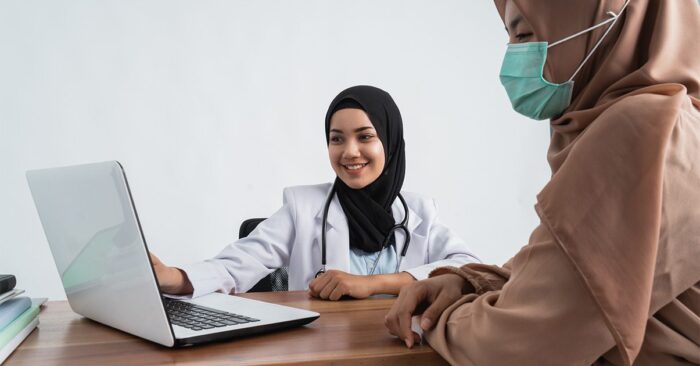 A doctor consulting with her patient.