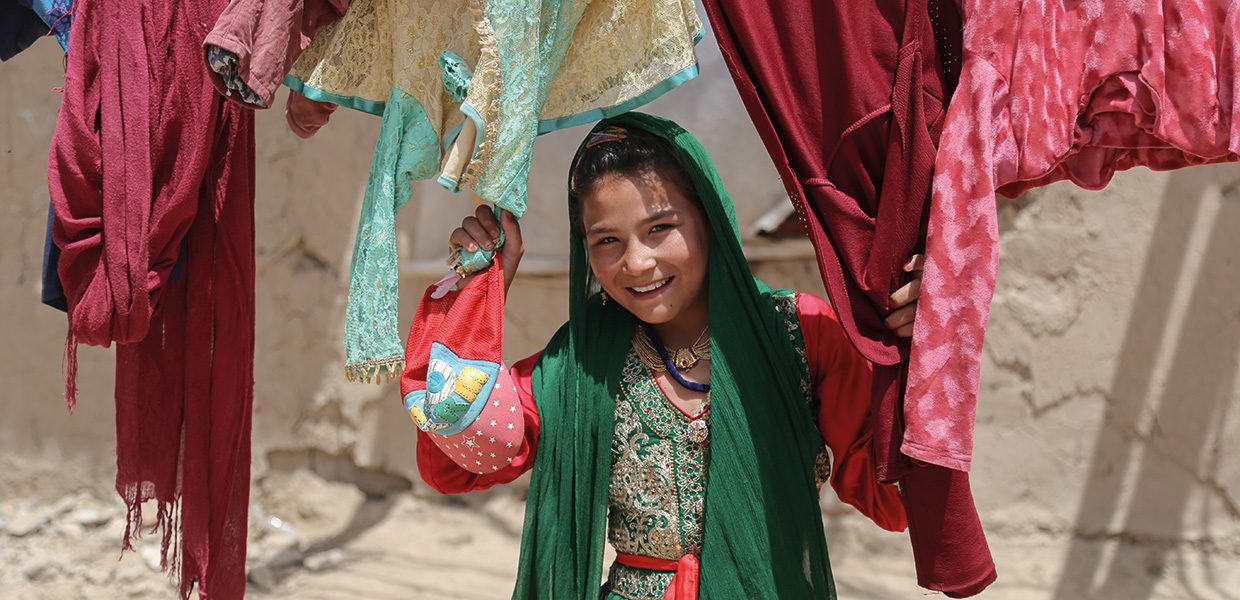 A young girl in Afghanistan holding a bag