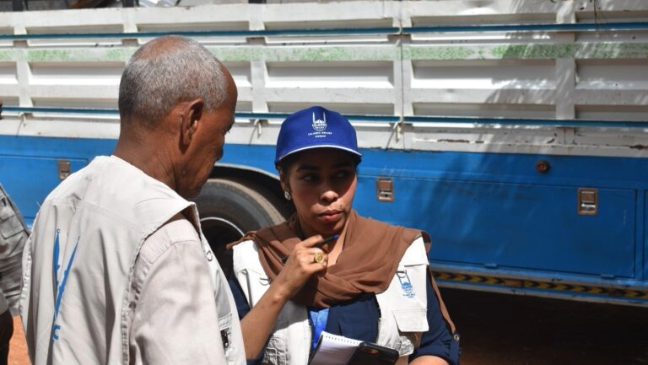 a sudanese man talking to a female islamic relief staff member