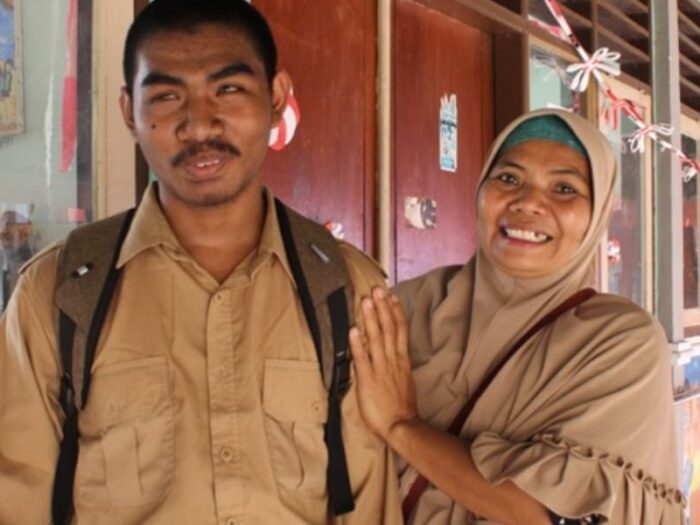 an indonesian man called iwan smiling and standing alongside a woman
