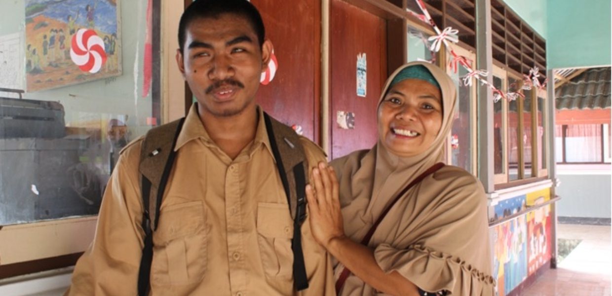 an indonesian man called iwan smiling and standing alongside a woman