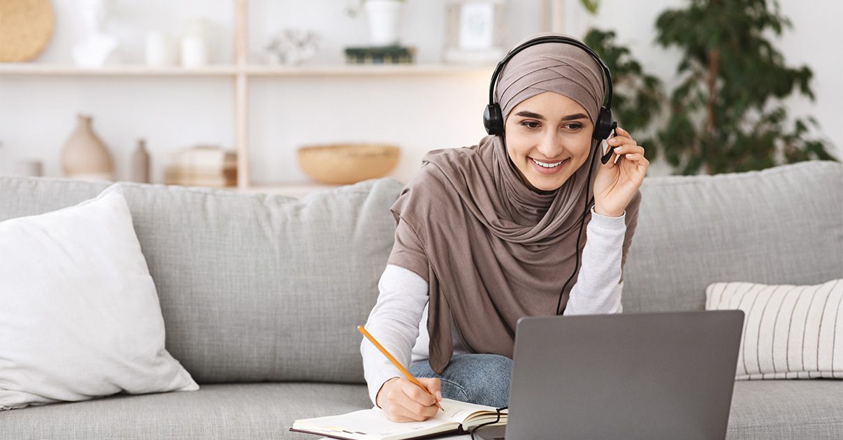 A lady working on her laptop at home.