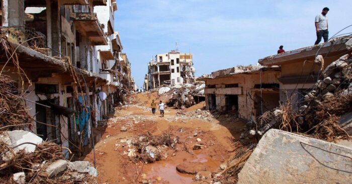 a street in libya impacted by the floods with mud, buildings collapsed and rubble
