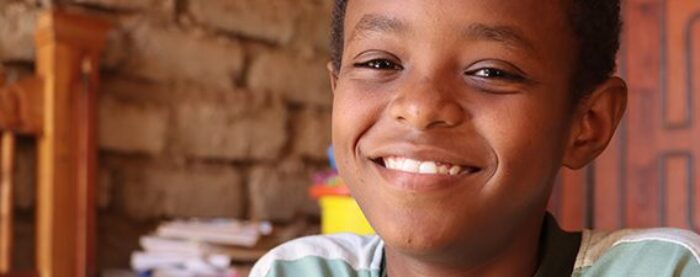 suhaib a young boy from sudan who is also a sponsored orphan by islamic relief, smiling to camera