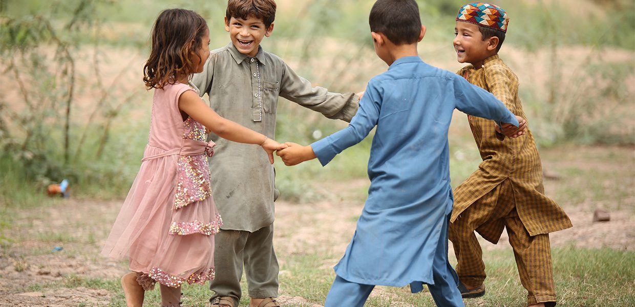 Children holding hands and playing in a circle