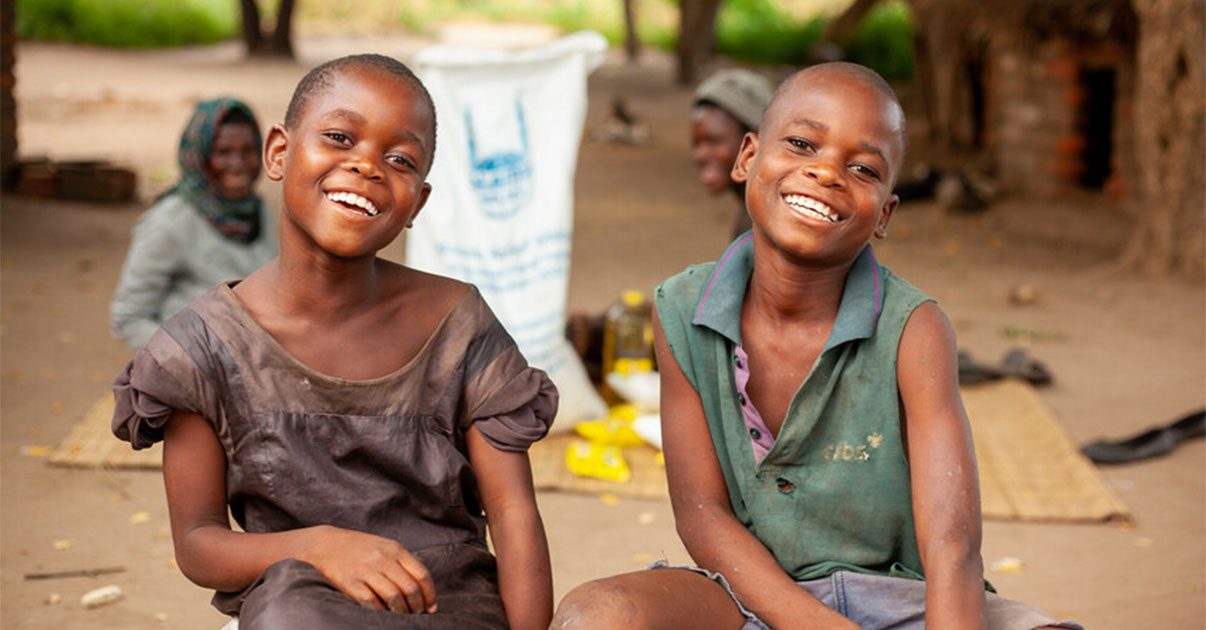 two girls from malawi smiling after receiving food donations in ramadan from islamic relief power of zakat