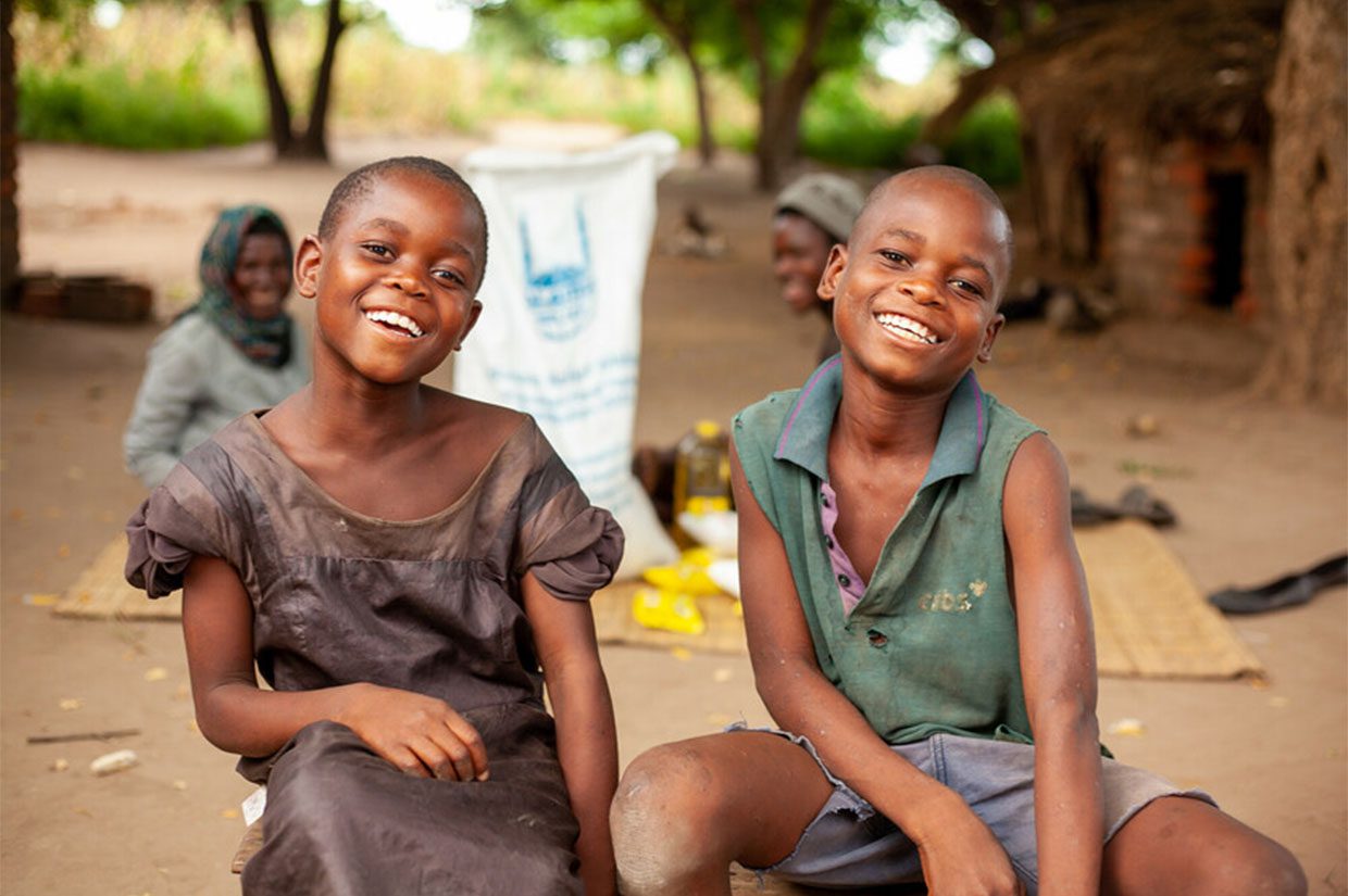 two girls from malawi smiling after receiving food donations in ramadan from islamic relief power of zakat