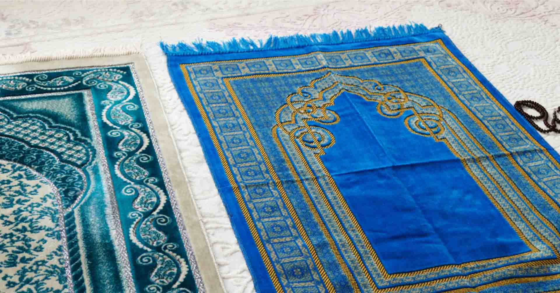 two blue and turquoise prayer mats derby