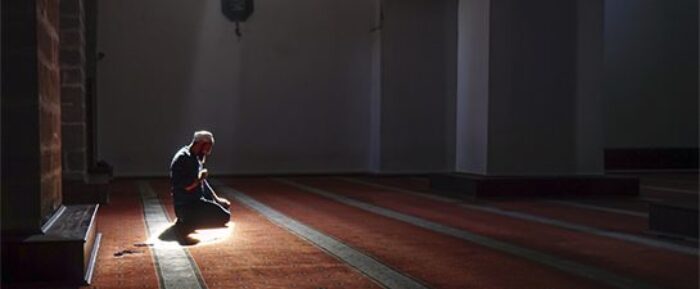 man in masjid performing prayer salah prayer timetables