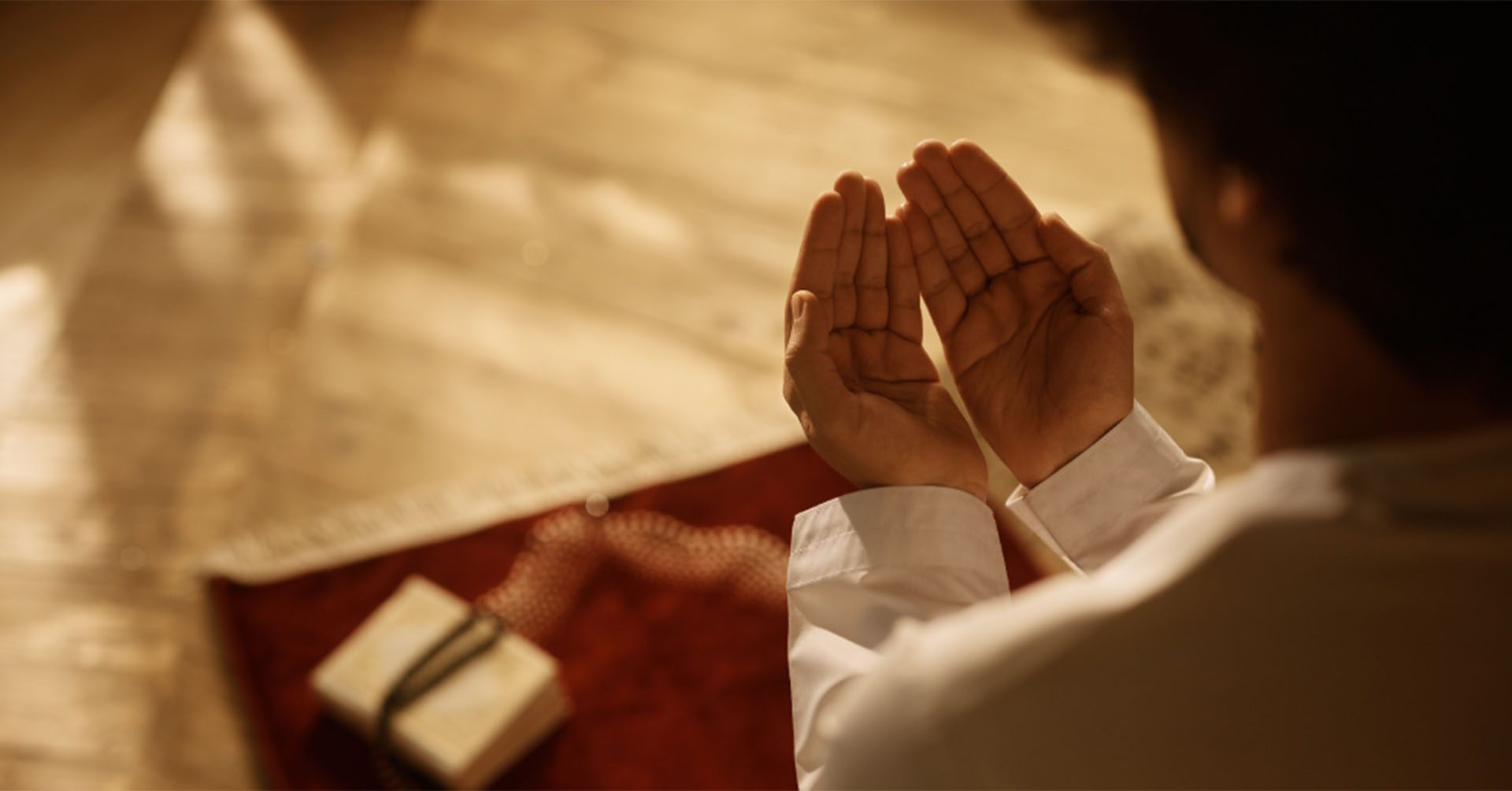 man with open hands in front of him offering dua prayer salah timetables belfast