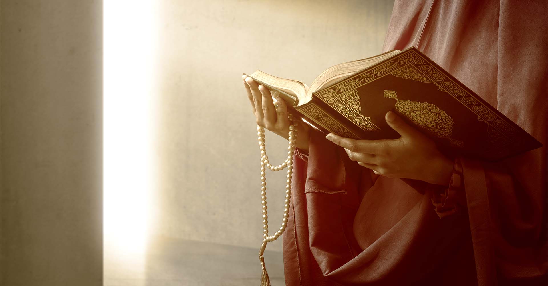 women holding quran and prayer beads (tasbih) prayer timetables oldham