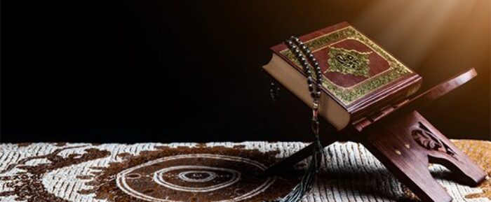 quran and prayer beads (tasbih) on prayer mat for salah prayer timetables