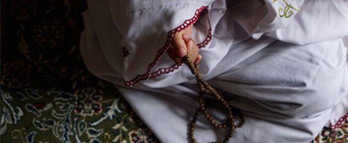 women doing dhikr with prayer beads (tasbih) on prayer mat prayer timetables