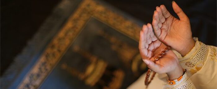 women doing dua with prayer beads (tasbih) on blue prayer mat prayer timetables