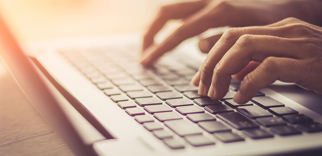 woman typing on a laptop press release