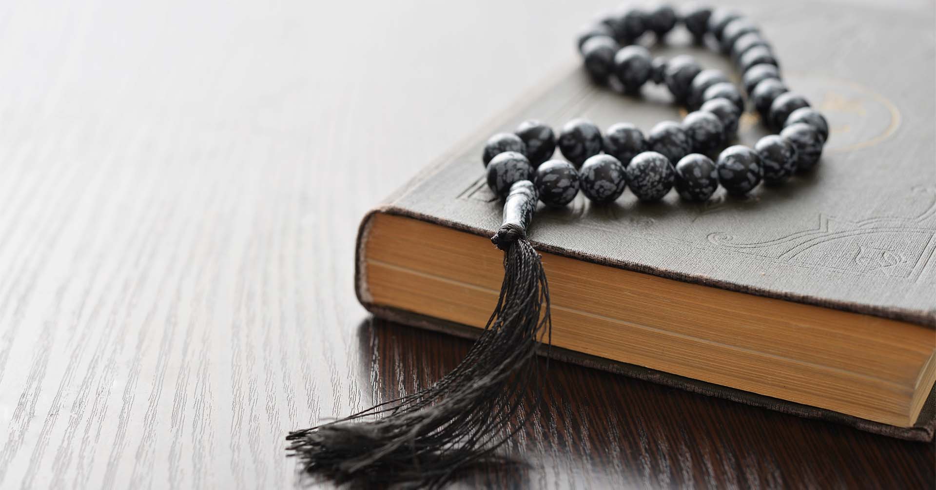 black prayer beads (tasbih) and quran rajab
