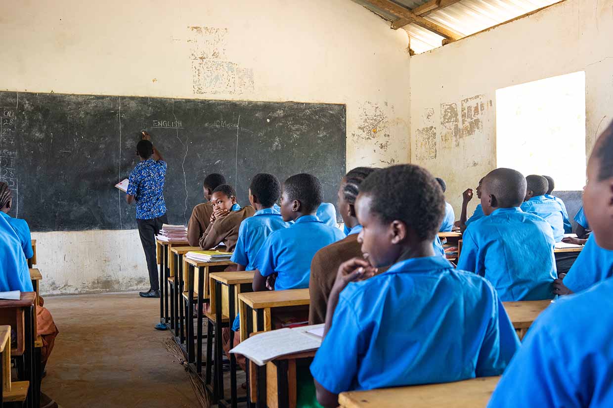 classroom of students listening to teacher in a school in kenya