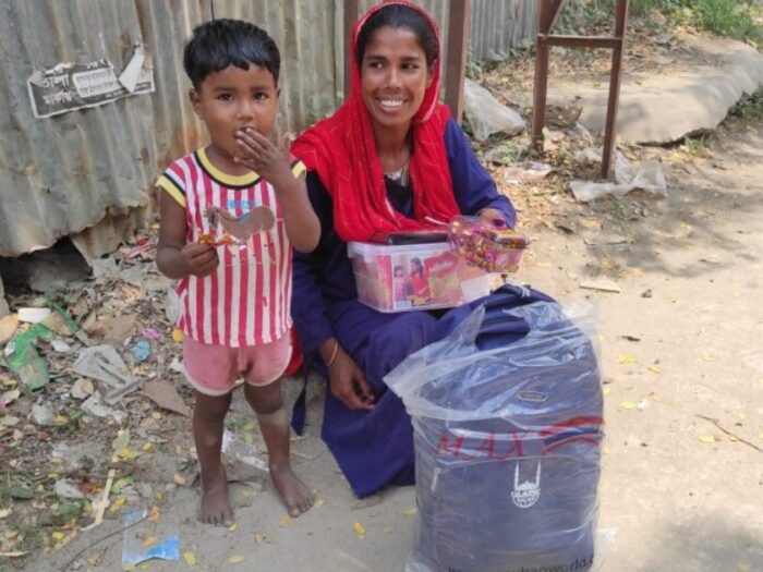 a rohingyan mother and child smiling as they receive gifts from islamic relief