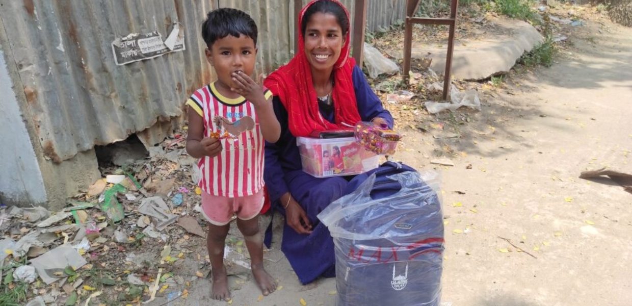 a rohingyan mother and child smiling as they receive gifts from islamic relief