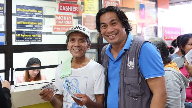 islamic relief teams in the philippines providing cash vouchers to people affected by the severe flooding in the region