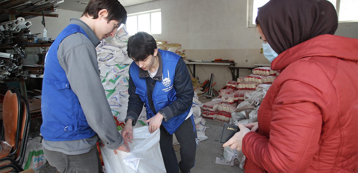 Islamic Relief staffing Chechnya putting materials in a bag.