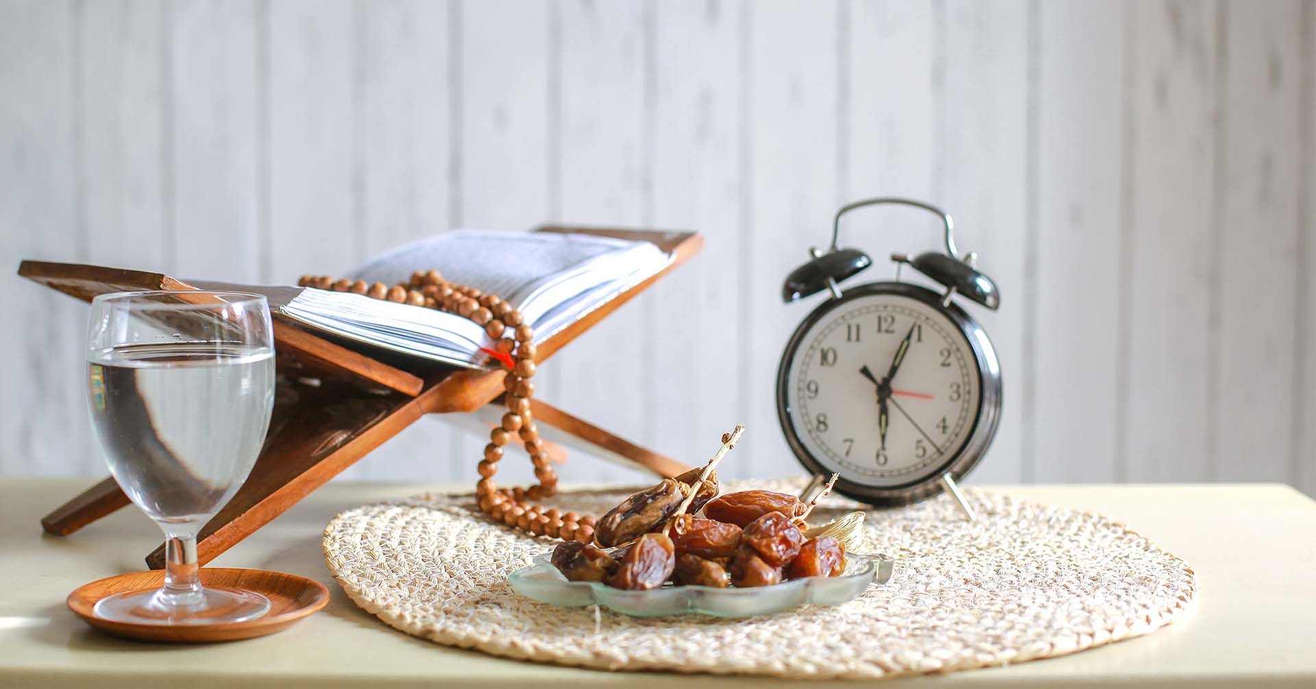 quran prayer beads (tasbih) glass of water bowl of water and clock ramadan sawm fasting