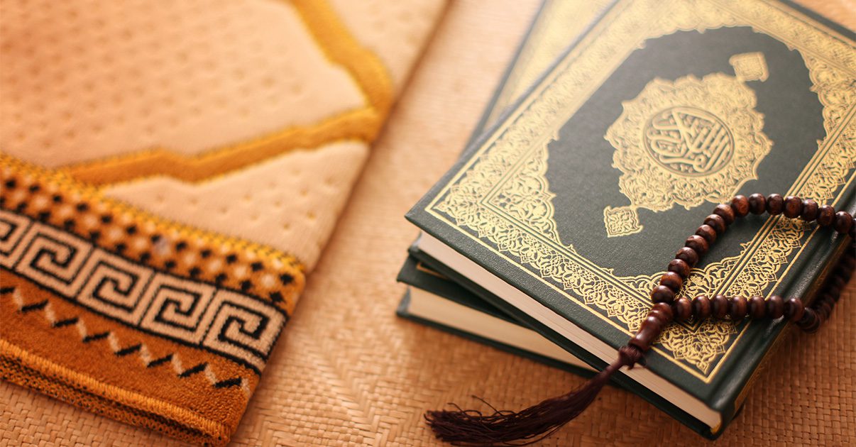 A prayer mat, prayer beads and Holy Quran.