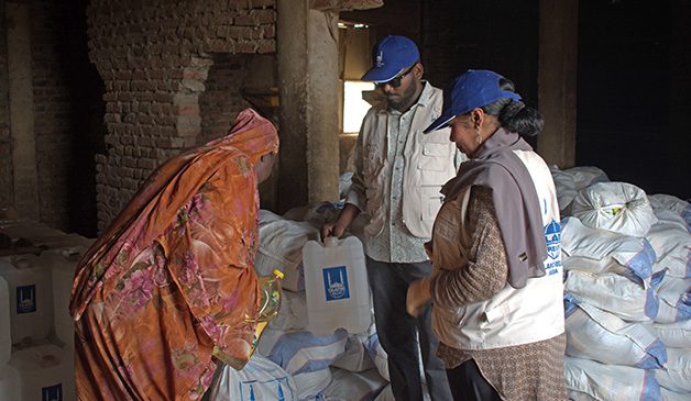 a rightsholder from sudan collecting non-food items and food packs from islamic relief following ongoing conflict in the region