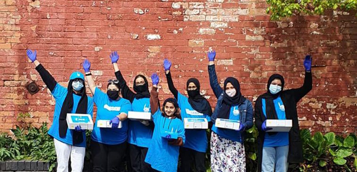 Islamic Relief volunteers with their arms raised