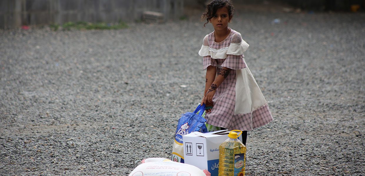 Girl with food items provided by Islamic Relief