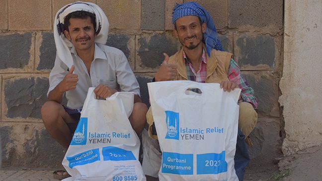 two yemeni smiling after receiving food packs as part of islamic relief qurbani distribution