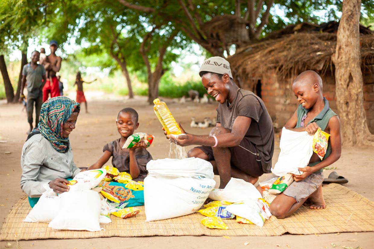 a family in malawi celebrating with happiness upon receiving a food pack from islamic relief zakat al fitr zakat ul fitr fitrana