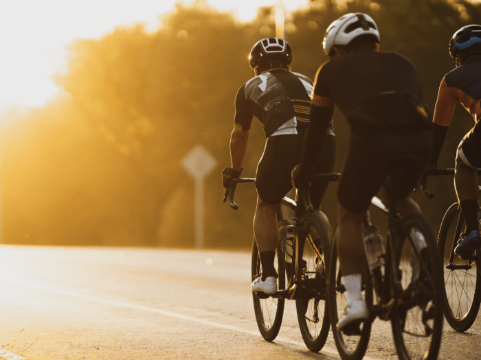 Group of cyclists in early morning sun